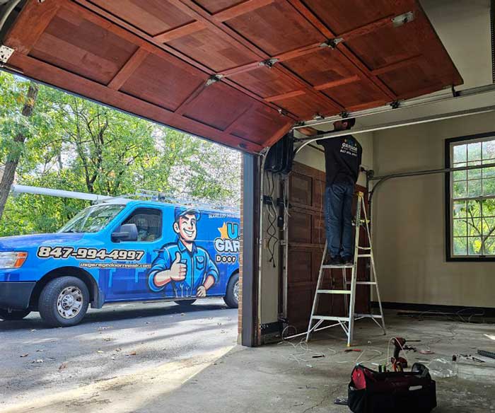 US Garage Door Repair technician working on a garage door in Long Grove IL